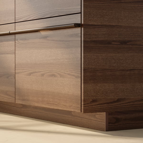 Dark brown wooden kitchen cabinet with long metallic handle.