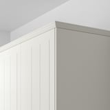 White panel with vertical grooves and top lighting.