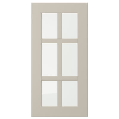 Beige STENSUND cabinet with glass doors and framed panels.