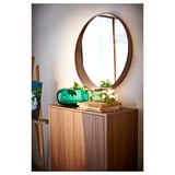 With STOCKHOLM walnut mirror, a window to your style. Circular wooden frame, glass, and shelf.
