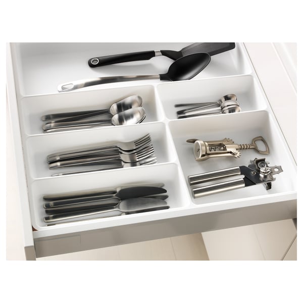 Cutlery organizer in drawer, keeps items neat and easily accessible.