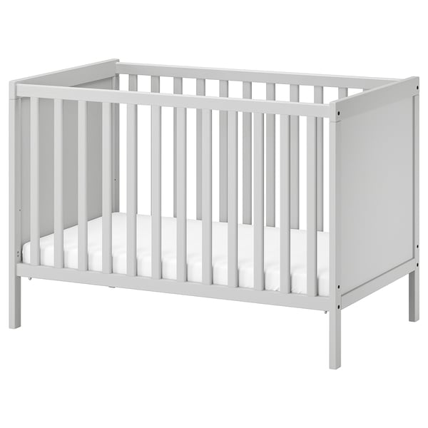 White ikea SUNDVIK baby crib with slatted sides and base, in minimalist modern design.