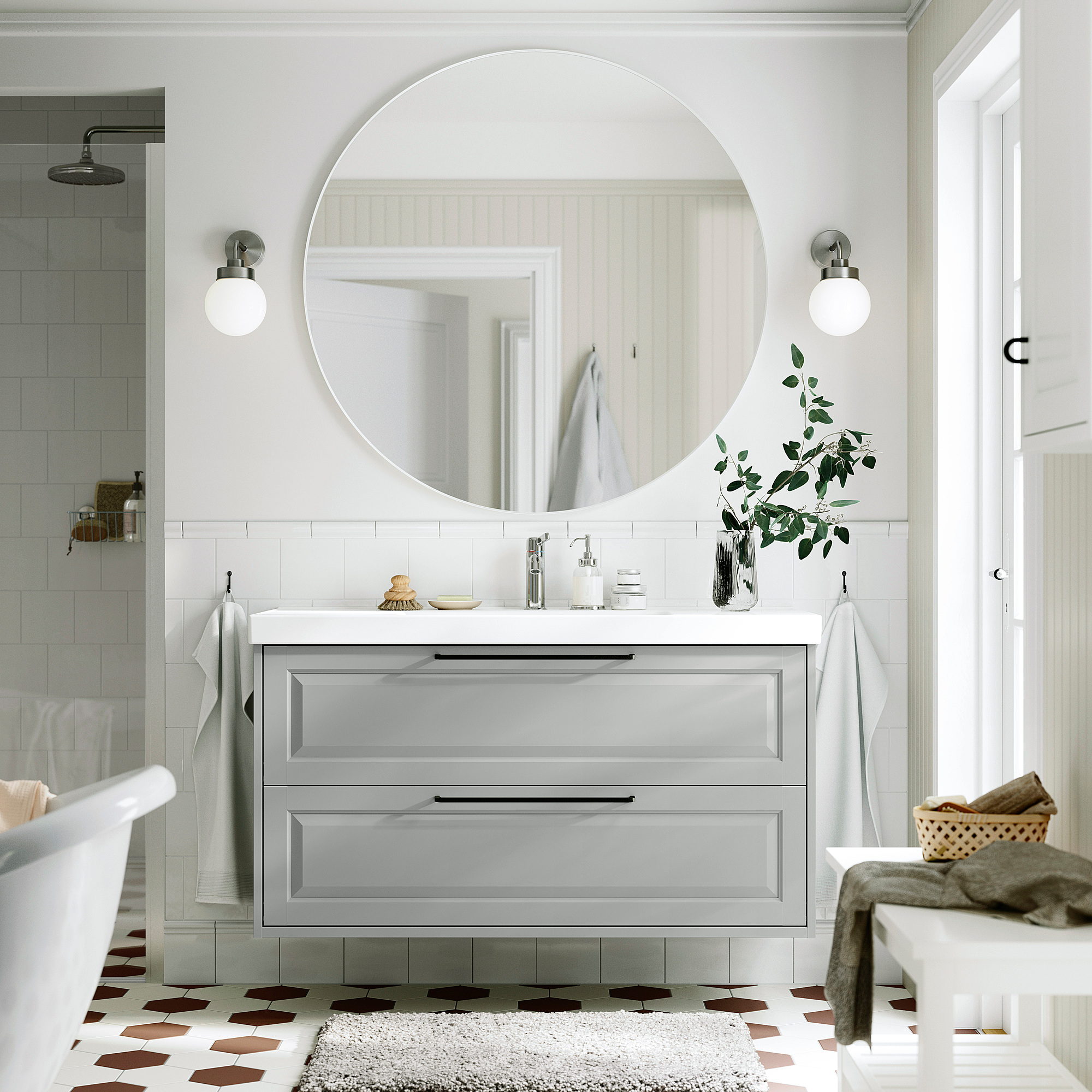 Gray bathroom vanity with mirror, lights & plants.