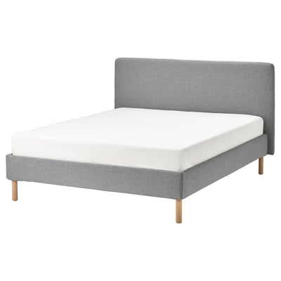 Minimalist gray bed with wooden legs, padded headboard, clean lines, and removable washable cover.