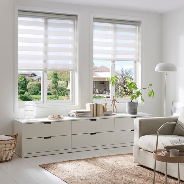 Modern living room with TANDLUNDFLY blinds, decor cabinet, chair & table.