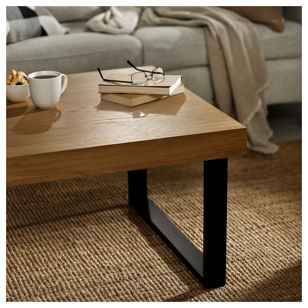 Lightning coffee table TARSELE wood, black metal legs, books, cup.