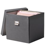 A TJOG storage box, dark gray, rectangular with a lid slightly ajar revealing pink items inside, featuring a metal label holder.