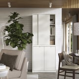 Modern living room with white TONSTAD cabinet, large plant, and stylish furniture.