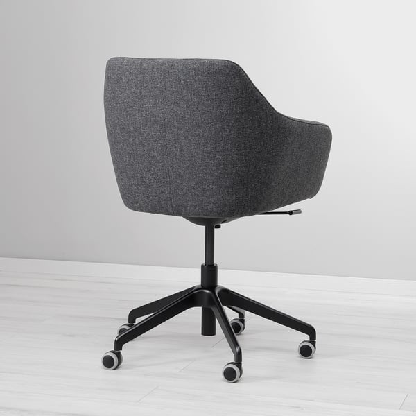 Modern swivel chair with dark grey fabric, soft padding, and sturdy castors.