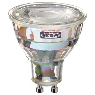 A clear, spherical smart led light bulb by ikea, named TRÅDFRI, with a metallic base, designed for energy efficiency and remote control.