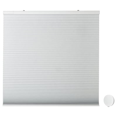 White cordless TREDANSEN blind with remote control, featuring block-out cellular design for light control.
