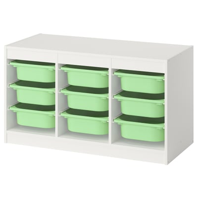 A TROFAST storage unit with white frame and green plastic boxes. Its a low, rectangular design for kids rooms.