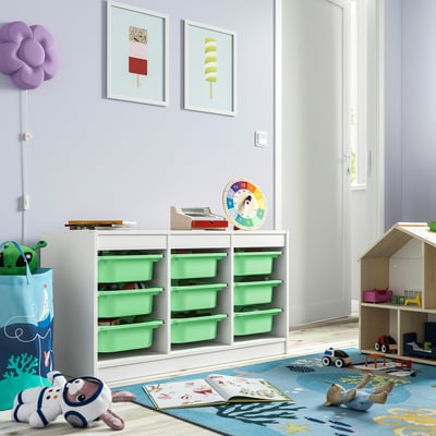 Kids room with TROFAST toy storage, art, rug, pillow, dollhouse, clock, book.
