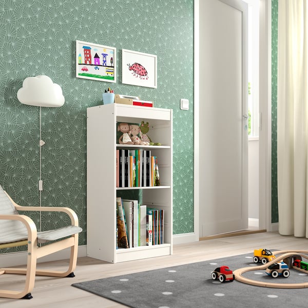 A white TROFAST childrens storage unit with shelves and toys in a playful room.