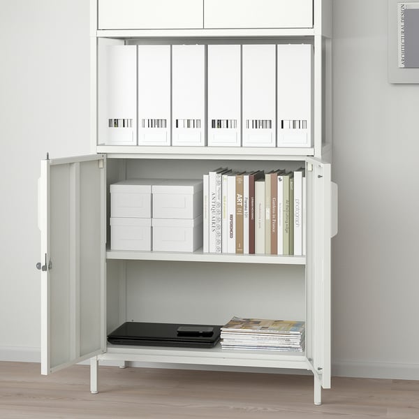 White cabinet with adjustable shelves, lockable doors, and adjustable feet, storing files and books.