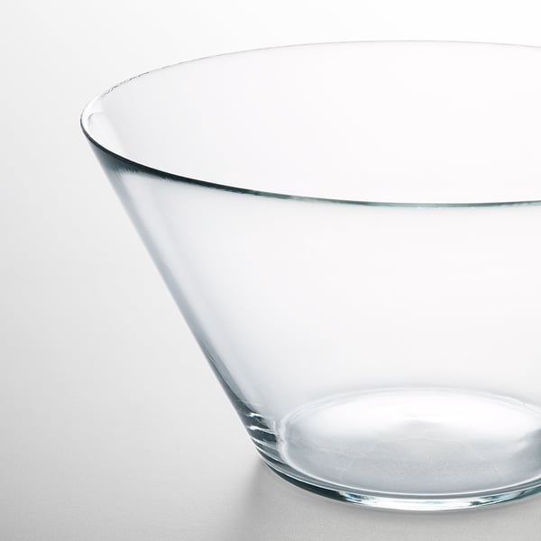 Clear glass bowl with smooth, curved edges. Transparent, reflecting light gently, showcasing sleek modern design.