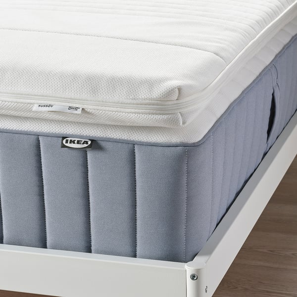 IKEA TUSSÖY mattress pad on bed with memory foam for pressure relief.