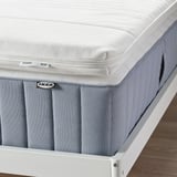 IKEA TUSSÖY mattress pad on bed with memory foam for pressure relief.
