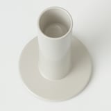 Single white cylindrical candleholder on round base, simple and modern design.