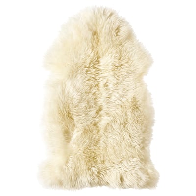 A soft, white, fluffy sheepskin rug, perfect for floors or furniture, offering warmth and comfort.