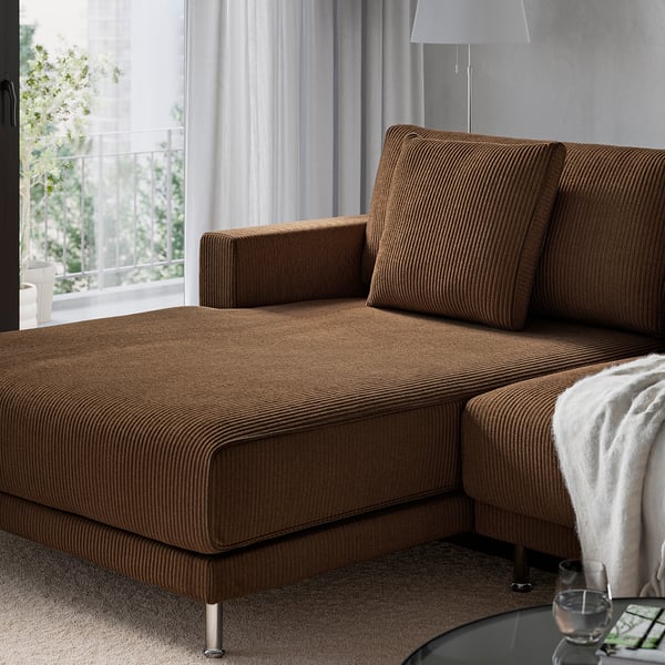 Brown UPPÅKRA sectional sofa with chaise, large cushions, and chrome legs by window.
