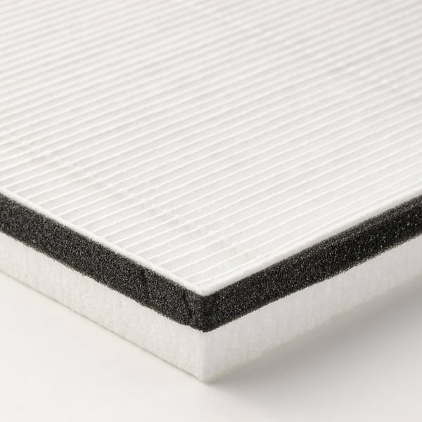 Close-up of a white air filter with a dense, textured surface, surrounded by a dark frame.
