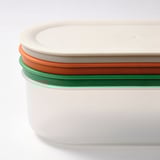 Stacked round storage containers with colorful seals, white bodies, and secure lids.