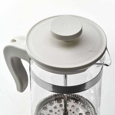 A white cafetière coffee maker with a clear glass jar, stainless steel mesh philtre, and plastic lid, handle, and base.