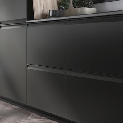 Modern kitchen with UPPLÖV black cabinets, sleek handles, and wooden floor.