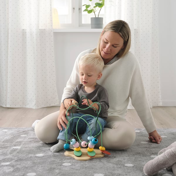 Woman & child play with UPPSTÅ wooden toy, learning colors & shapes