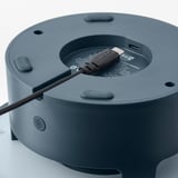 Image shows a portable speaker with a charging port, likely for outdoor use.