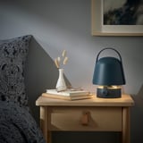 VAPPEBY lamp on bedside table with dried flowers and books.