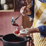 Chef scoops jam with ladle.