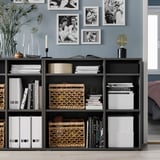 Modern black VIHALS storage unit with personal items.