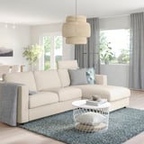 Modern living room with VIMLE cream sofa, chaise, colorful cushions, pendant light, side table, rug, drapes, plants.