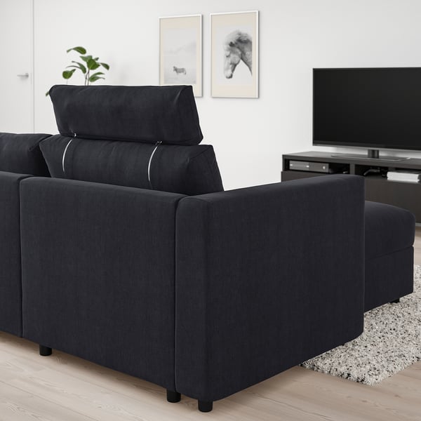 Modern dark grey VIMLE sectional sofa in living room with tv & plant.