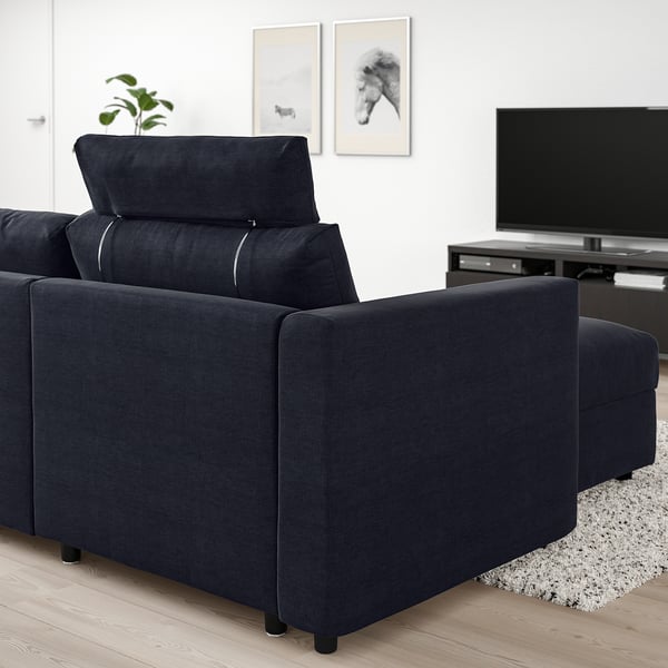 Dark blue VIMLE sofa section with headrest in modern living room.