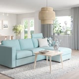 Modern living room with blue VIMLE sectional, wooden tables, and pendant lamp.