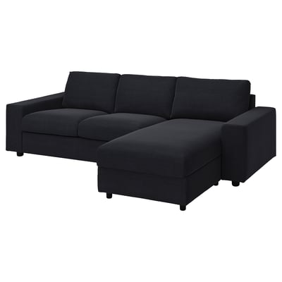 Black l-shaped sofa with sectional chaise, modern design, dark grey upholstery, clean lines, supportive cushions.