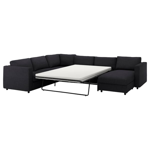 The VIMLE sectional sofa in dark gray a convertible sofa bed with a white mattress, providing a multifunctional seating and sleeping solution.