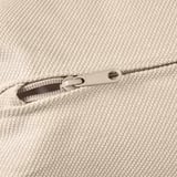 Close-up of white zipper on textured, woven beige fabric, showcasing quality craftsmanship.