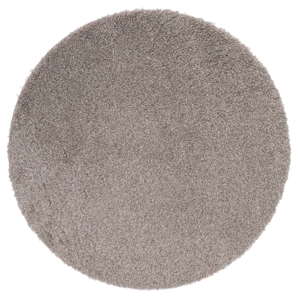 Soft grey shaggy circular rug, made from recycled polyester. Provides a cozy feel and reduces noise.