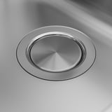 Stainless steel sink drain cover, polished finish, fits flush.