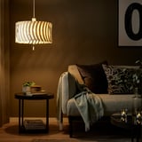 Cozy living room with YTLÄGE lamp, brown shade, gray sofa, green pillows, and plant.