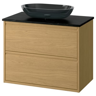Meuble de salle de bain moderne en chêne avec plan de travail noir et bassin en verre.