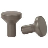 Deux boutons d’armoire cylindriques lisses, gris et aux sommets arrondis, posés sur un fond blanc.