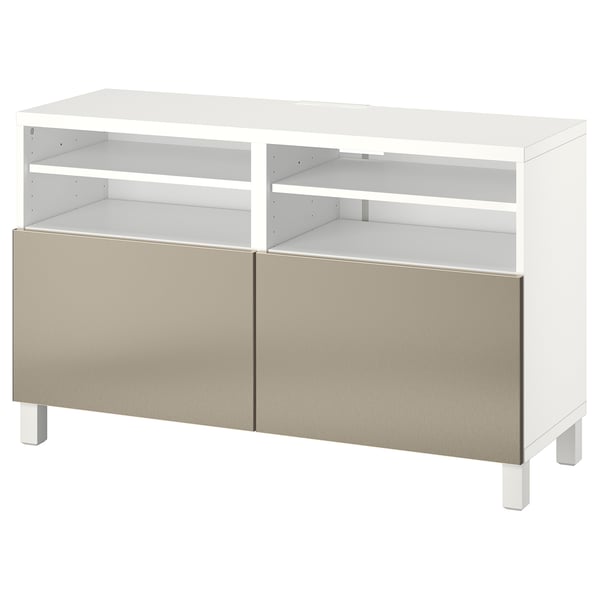 Meuble TV BESTÅ blanc avec portes dorées, design moderne, étagères réglables et gestion des câbles.