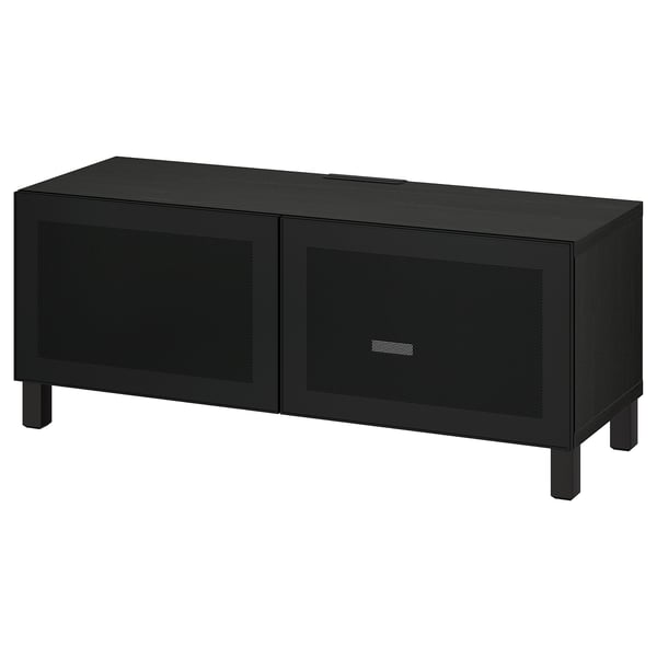 Meuble TV BESTÅ noir avec deux portes grillagées, pieds carrés, design moderne pour la gestion des câbles.