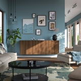 Salon moderne avec buffet BESTÅ , galerie d’art et table en verre entre des canapés blancs.