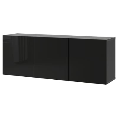 Une armoire murale ikea BESTÅ noire. Rectangulaire, avec des portes élégantes et brillantes et un design moderne pour le rangement.